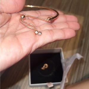 Rose gold Pandora bracelet with pendant of hearts that’s say i love you